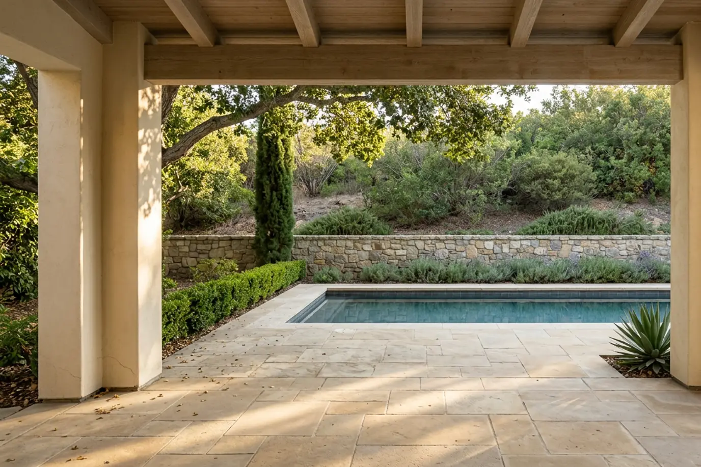 A stone-walled patio and pool beside a chaparral hillside (illustrative foothill-style image, not this canyon)