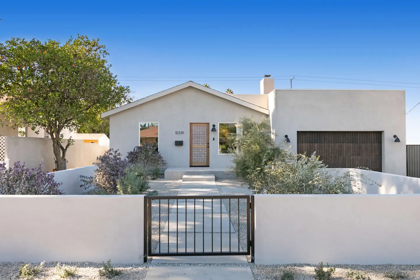 A white stucco home behind a gate in Sunland